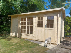 Northern_log_cabins_6 log cabin in garden with dog